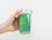 A hand holding a clear cup filled with green beverage and a glass straw, branded with the 'Randy's' logo against a light background