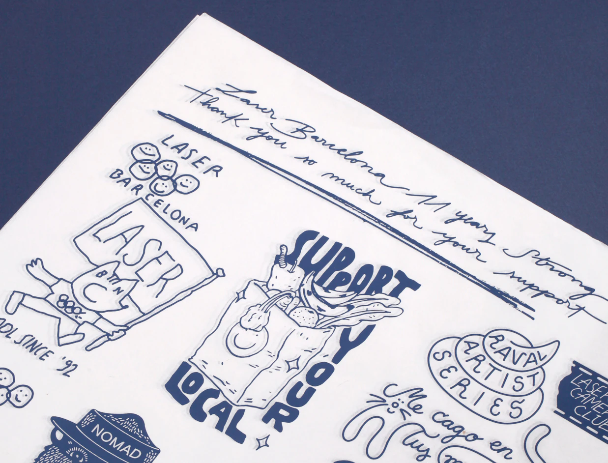 Close-up of white tissue paper with a navy hand-drawn illustration and lettering print