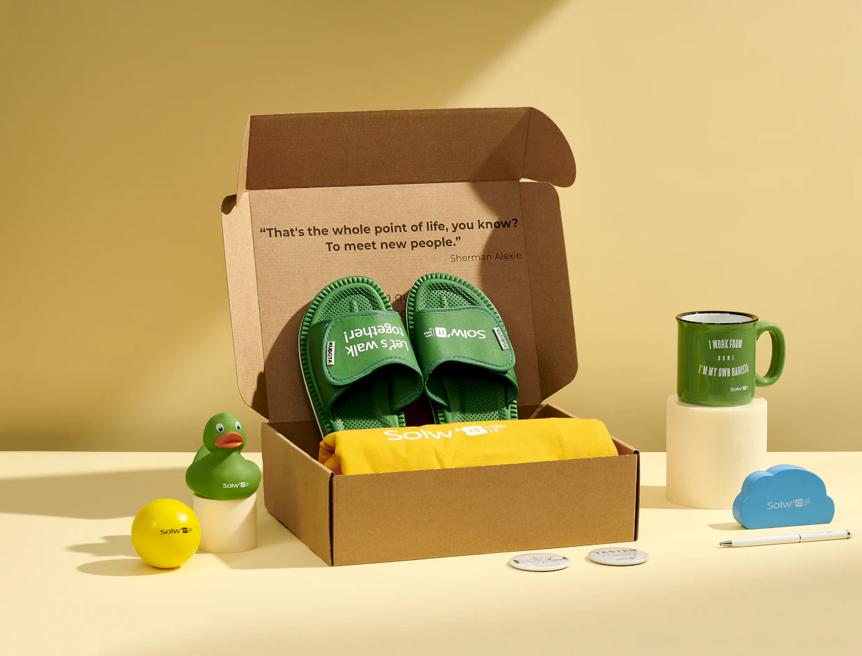 Open kraft eco mailer box with a one-colour black print inside the lid, packed with branded merchandise