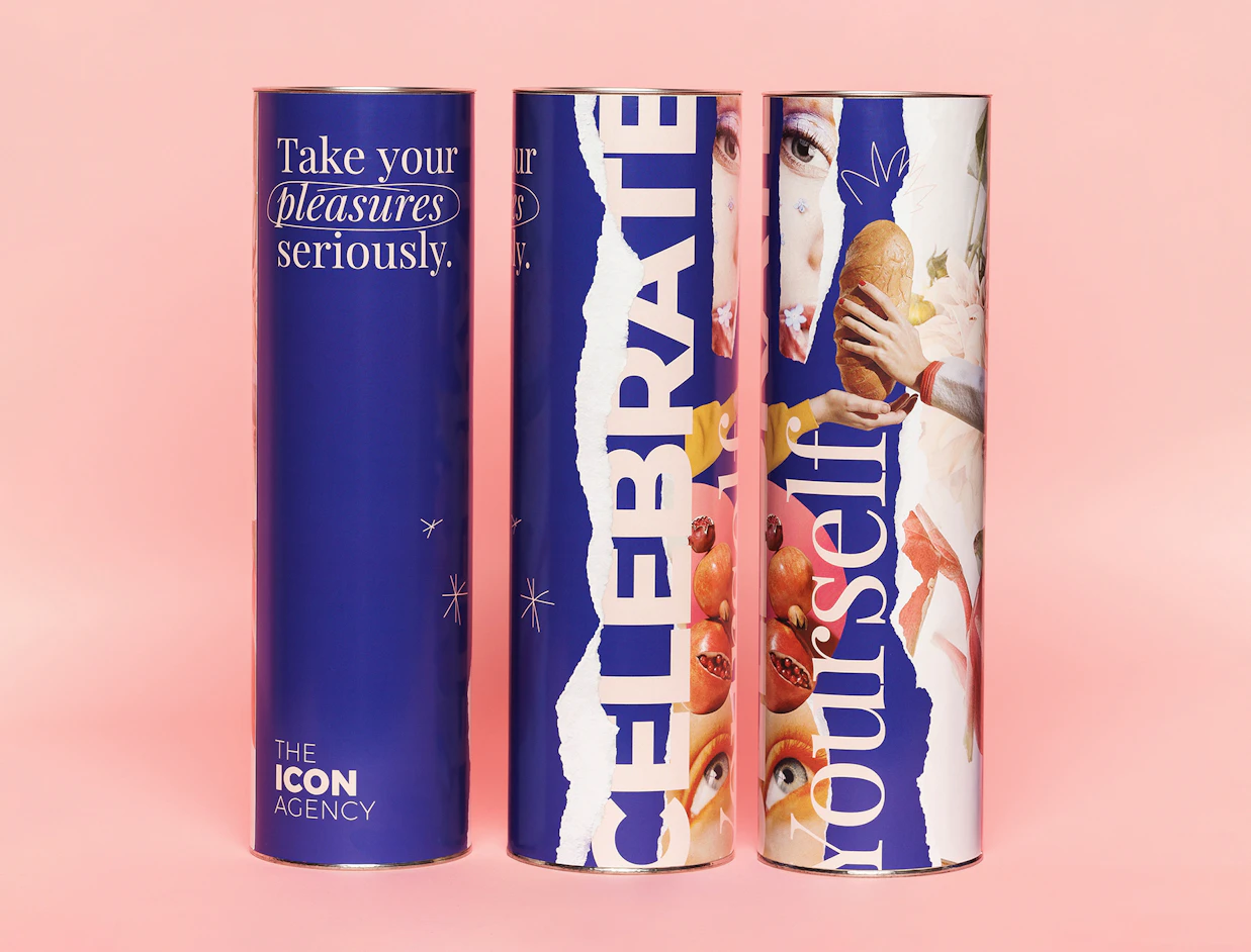 Three tall navy paper cans with bold full-colour prints on a pink background