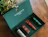 An open forest green presentation gift box containing four Sord men's grooming products, with the inner lid printed 'Do not just face the day. Own it