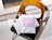 Poly mailers with a purple graphic pattern lying on a chair