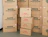 Stacked kraft shipping boxes with green and red prints in a warehouse