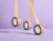 Three rolls of brown kraft paper tape printed with 'FRAGILE' text hanging in the air against a light purple background
