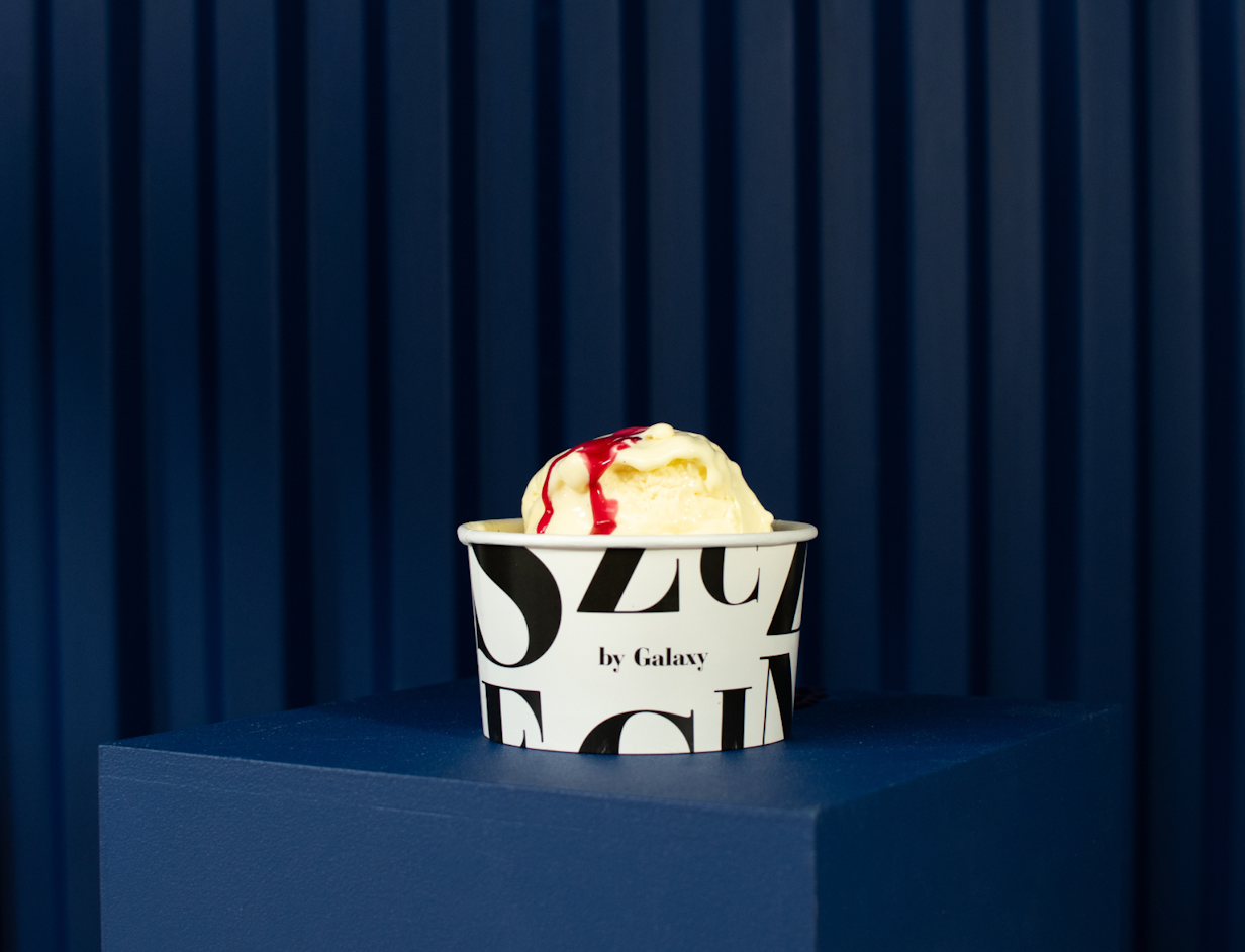  Ice cream cup with "by Galaxy" text, filled with ice cream and topping