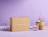 A brown cardboard box sealed with kraft paper tape printed 'FRAGILE', displayed on a purple background next to printed drinking glasses and rolls of tape