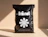 A black poly mailer bag printed with 'kind' and a white floral graphic, labeled 'MADE FROM 100% RECYCLABLE MATERIAL'