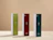 Three tall wine gift boxes in green, burgundy red, and dark green labeled 'Vegan WINE GIFTS' standing on a light surface