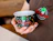 Close-up of a person wearing a brown apron holding an empty black paper ice cream cup with the 'Passione' logo