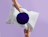 A white poly mailer with a purple circle graphic, held in both hands