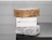 Three stacked eco mailer boxes in kraft and white cardboard, each with a one-colour black print