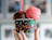 A hand holding a black paper cup labeled 'Passione' filled with scoops of chocolate and strawberry ice cream
