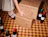Person stacking kraft shipping boxes with a black line illustration print beside wine bottles