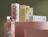 Collection of pastel Hemp Juice CBD oil boxes arranged on pink geometric display stands