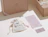 A small white cotton drawstring bag printed with 'biotika' next to brand information cards and cardboard shipping boxes