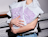 Poly mailers held in hands with a purple graphic pattern