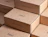 Rows of kraft eco mailer boxes with a minimal one-colour black logo print