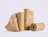 Several rolls of brown honeycomb protective wrapping paper standing together on a plain background