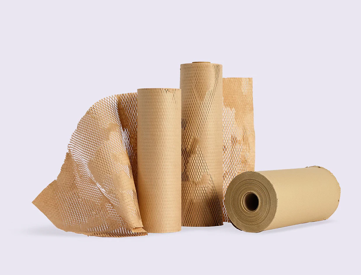 Several rolls of brown honeycomb protective wrapping paper standing together on a plain background
