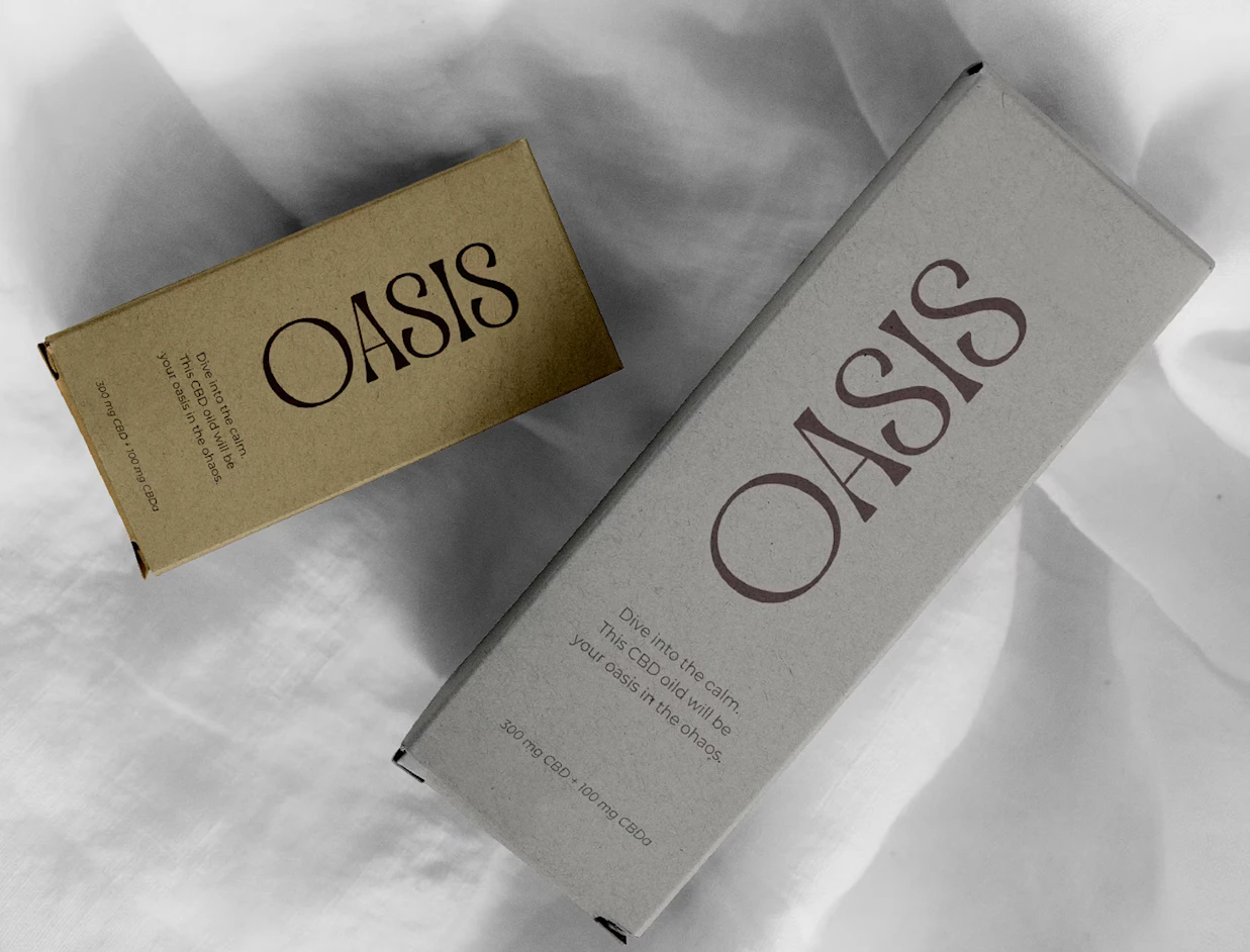 Two printed product boxes in olive and grey with black lettering on white fabric