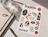 Sticker sheet titled 'TrackOn RUN CLUB' with running-themed stickers next to a notebook and a glass of water on a desk