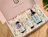 An open pink gift box filled with white biodegradable packing peanuts protecting three Yope bath and body products
