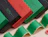 Row of eco colour mailer boxes in black, red and green with printed lettering