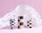 Three checkered ceramic vases standing in front of expanded white honeycomb packaging paper on a pink background