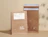 Two expandable kraft mailers with a white print and address labels, standing upright