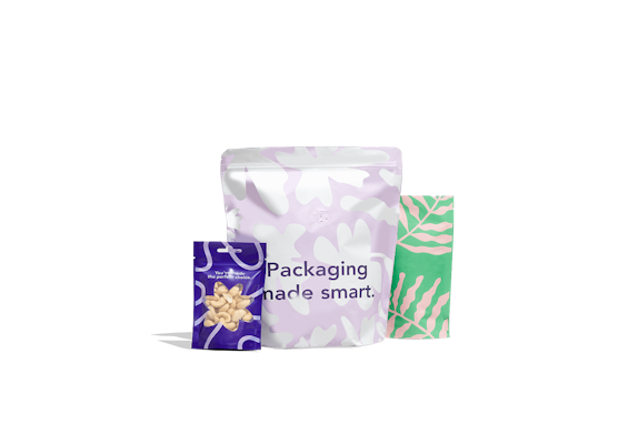 Three pouches: a purple one with print and a transparent window, a pastel purple one with white patterns and the text "Packaging made smart", and a green one with light botanical patterns