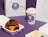 Pastry boxes and a paper cup with cartoon stickers next to chocolate and cream buns on a purple surface