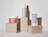 SoKind skincare products arranged on top of neutral cardboard boxes against a white wall