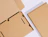 Top-down view of open and closed brown kraft laptop shipping boxes with internal cardboard stabilization inserts