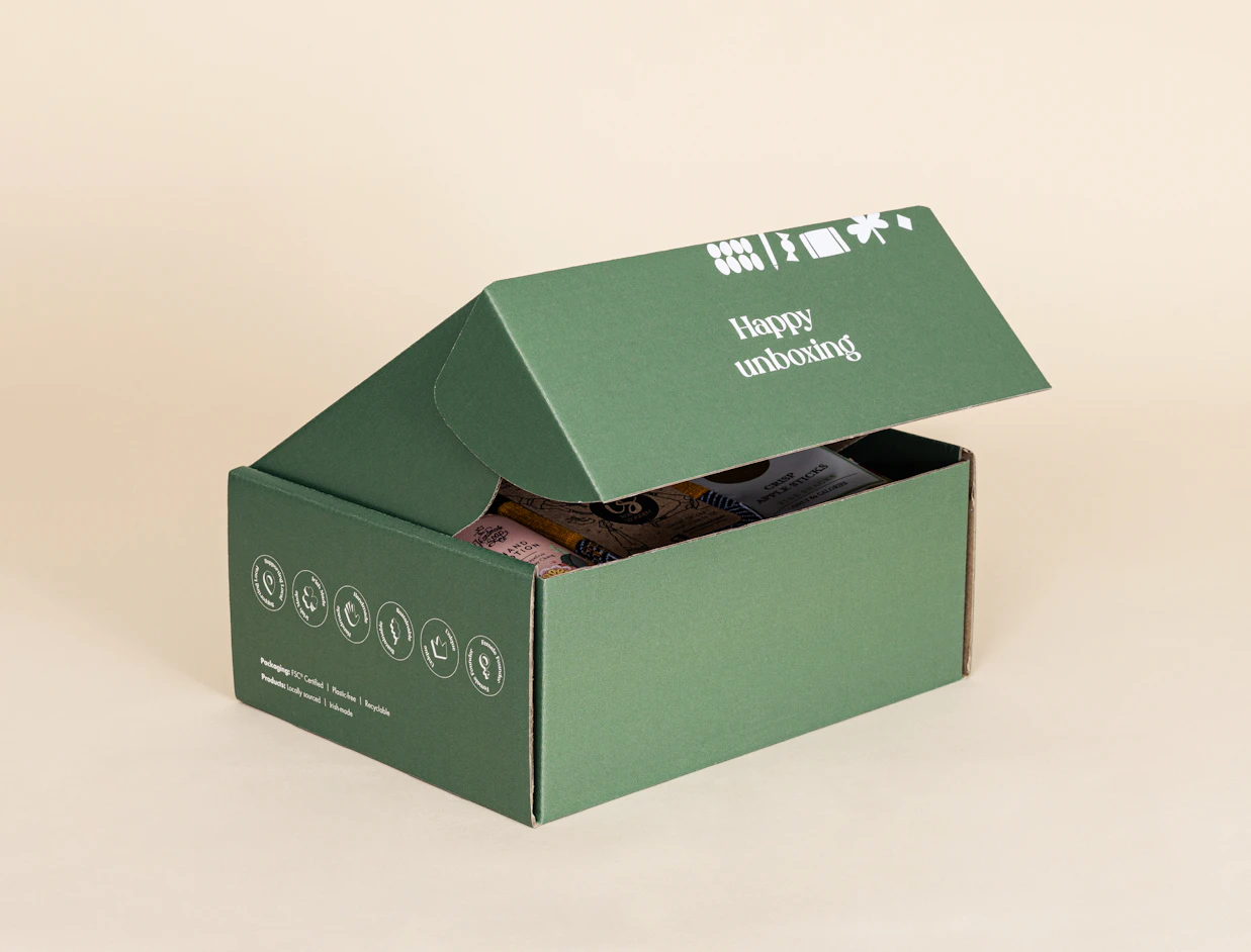 Open green eco colour mailer box with a white print on the lid, on a beige background