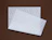Two sheets of white tissue paper with a diagonal white text print on a brown background