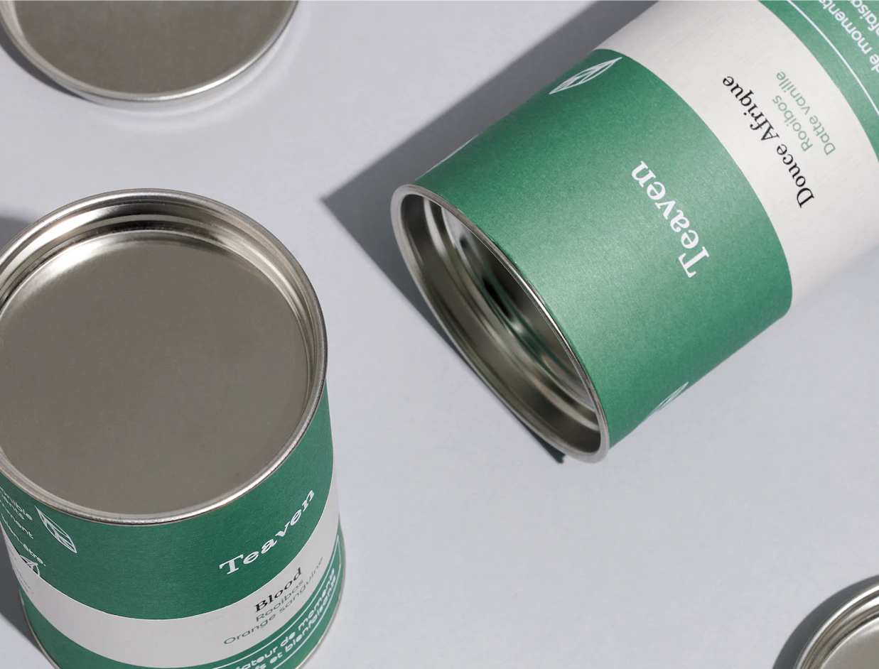 Close-up of green and white printed paper cans showing the metal rim