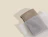 Frosted zipper bag holding a folded grey knit item on a beige background