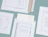 White cardboard mailer envelopes with notebook print details spread out on a light blue background