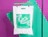 White bio poly mailer with a green print and die-cut handle hanging on a rail