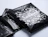 Stack of glossy black poly mailers printed with white playful geometric patterns and the logo 'christkind clothing'