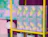 Tall bottle boxes with a colorful pastel gradient design branded 'beztrosko' arranged on a bright yellow shelf