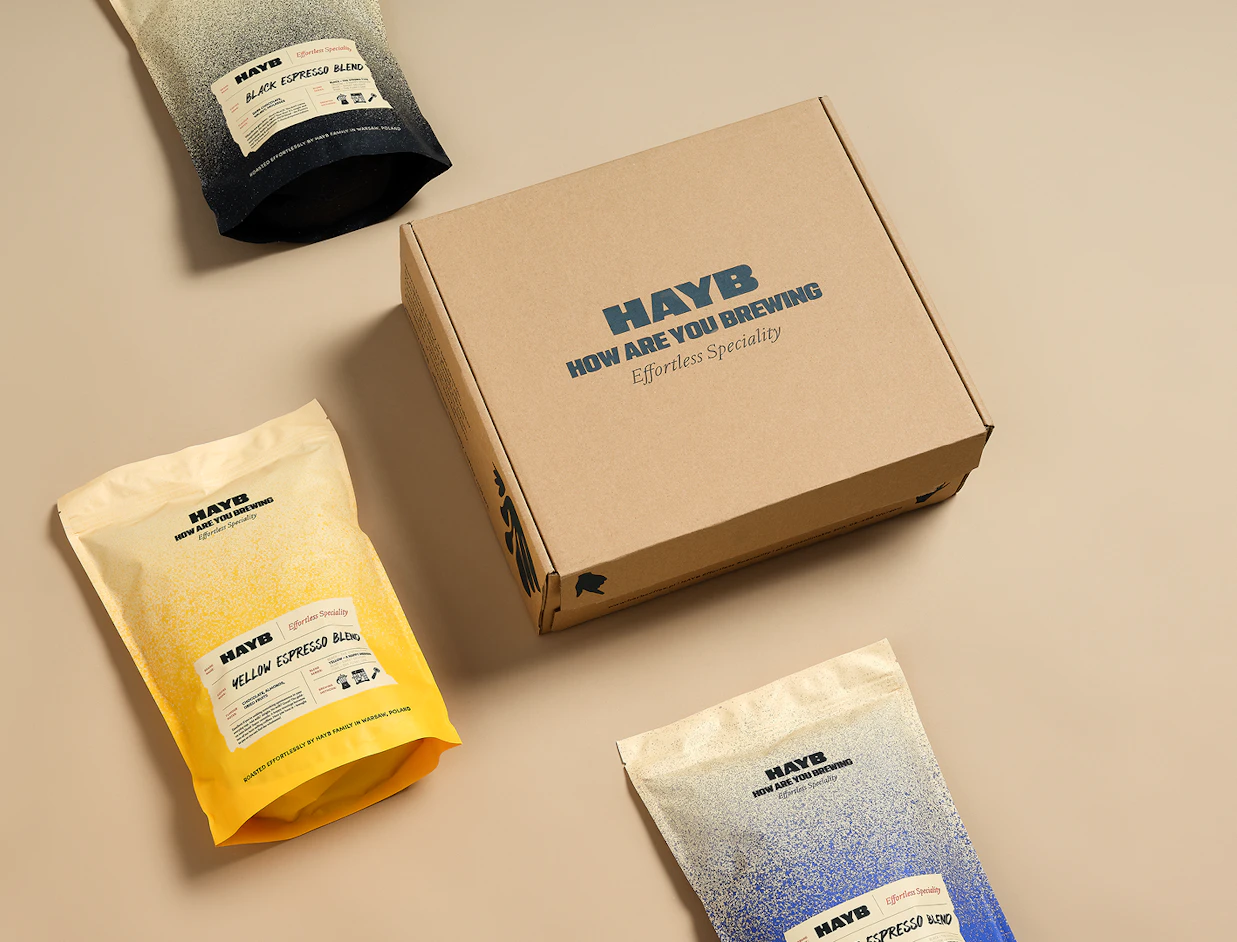 Kraft eco mailer box with a one-colour dark logo print on the lid, shown with coffee bags