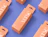 A flat lay of peach-colored 'verse' skincare boxes with euro-hang tabs on a purple background