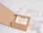 An open kraft cardboard book mailer displaying a book titled 'Hello Beautiful' with colorful tulip graphics inside