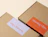 Kraft mailer boxes with rectangular white and orange custom labels on the lids