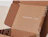 Open kraft mailer box with a white print inside the lid and along the side walls