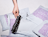 Five white poly mailers with a purple graphic pattern, including one that is open