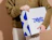 Person holding a white eco colour mailer box with a bold blue print