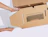 Hands sliding a silver laptop into a custom cardboard shipping insert printed with a keyboard illustration and website URL