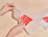 Hands opening a frosted zipper bag with a red lettering print